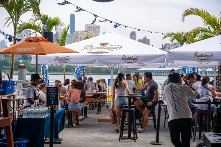 People hanging out at OktoberFest NYC 2023 at Watermark - Beer Festival