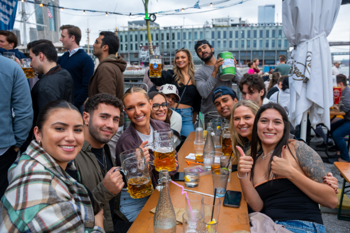 People having fun at OktoberFest NYC 2023 at Watermark - Beer Festival