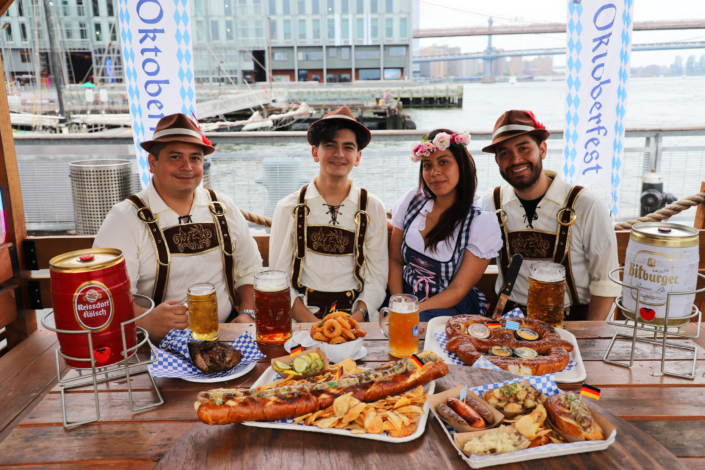 Team showcasing food & beer at OktoberFest NYC 2022 at Watermark