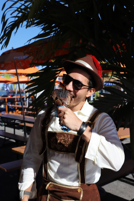 OktoberFest NYC Food - Man Eating Beer Braised Turkey Leg