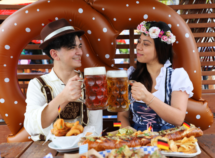 Couple enjoying food and beer at OktoberFest NYC 2022