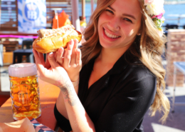 OktoberFest NYC Food - Girl enjoying a Bratwurst Sandwich