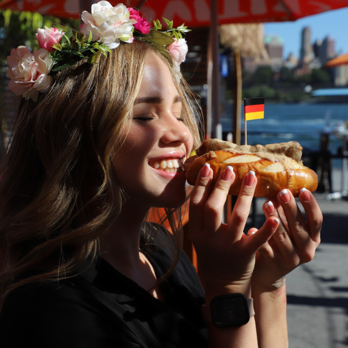 OktoberFest NYC Food - Girl eating a Bratwurst Sandwich