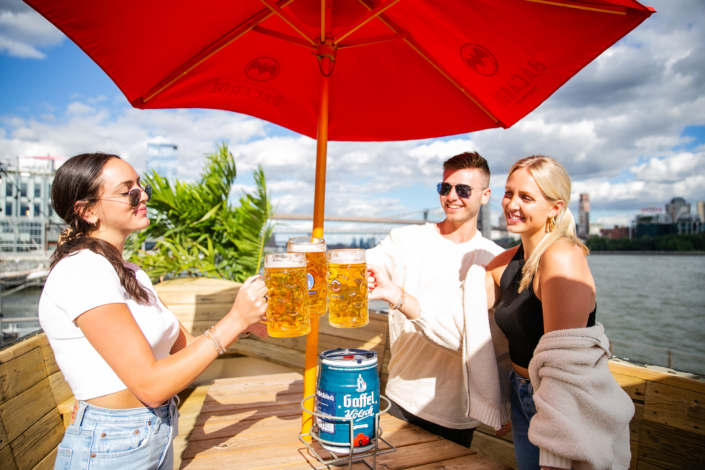 Friends Toasting with Beer and enjoying food at OktoberFest NYC 2021