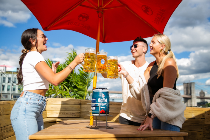 Friends Toasting with Beer and enjoying food at OktoberFest NYC 2021