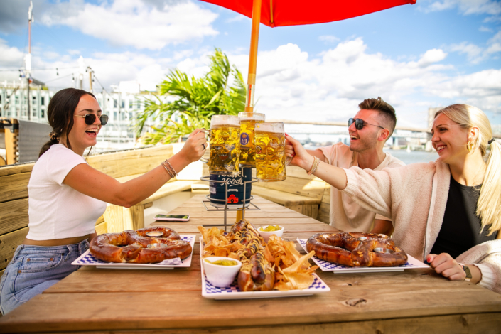 Friends Toasting with Beer and enjoying food at OktoberFest NYC 2021